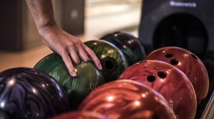 Man grabbing bowling ball