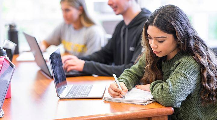 A student studies at a table