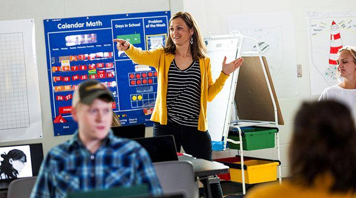 A teacher instructs students in a classroom
