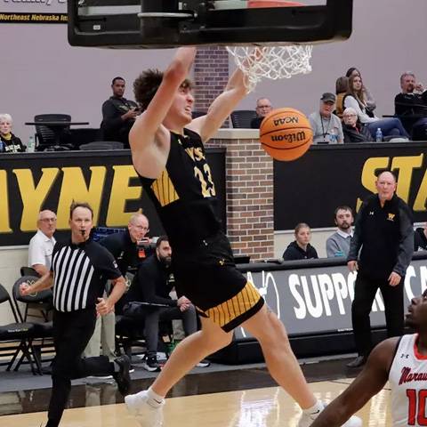Men's basketball player dunking the ball
