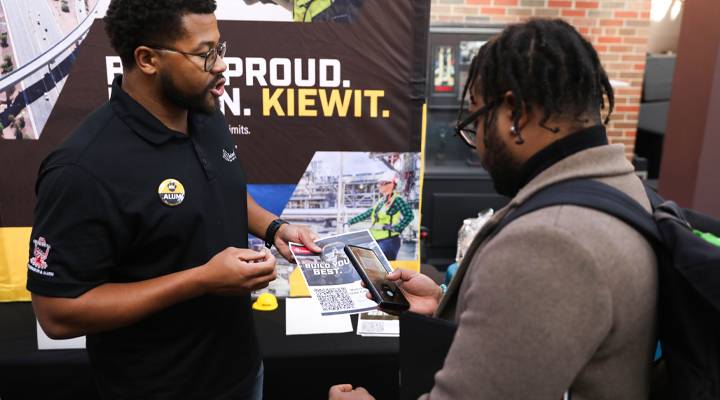 An employer discusses job opportunities with a student at the WSC Career Fair
