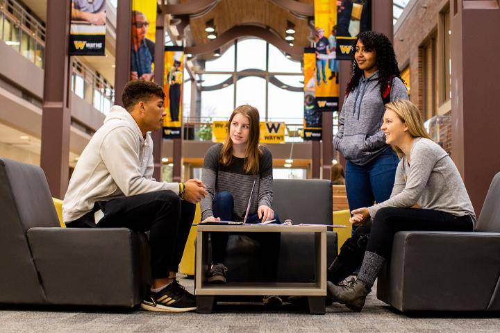 A small group of students gather in the Student Center