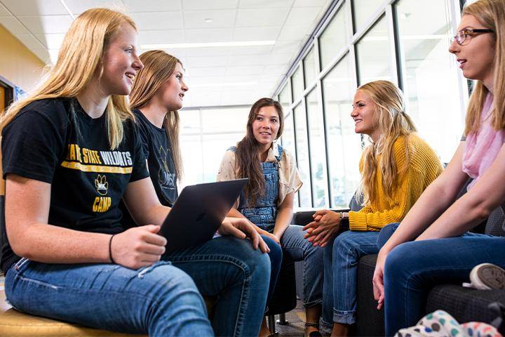 Students interact in the lobby of a residence hall