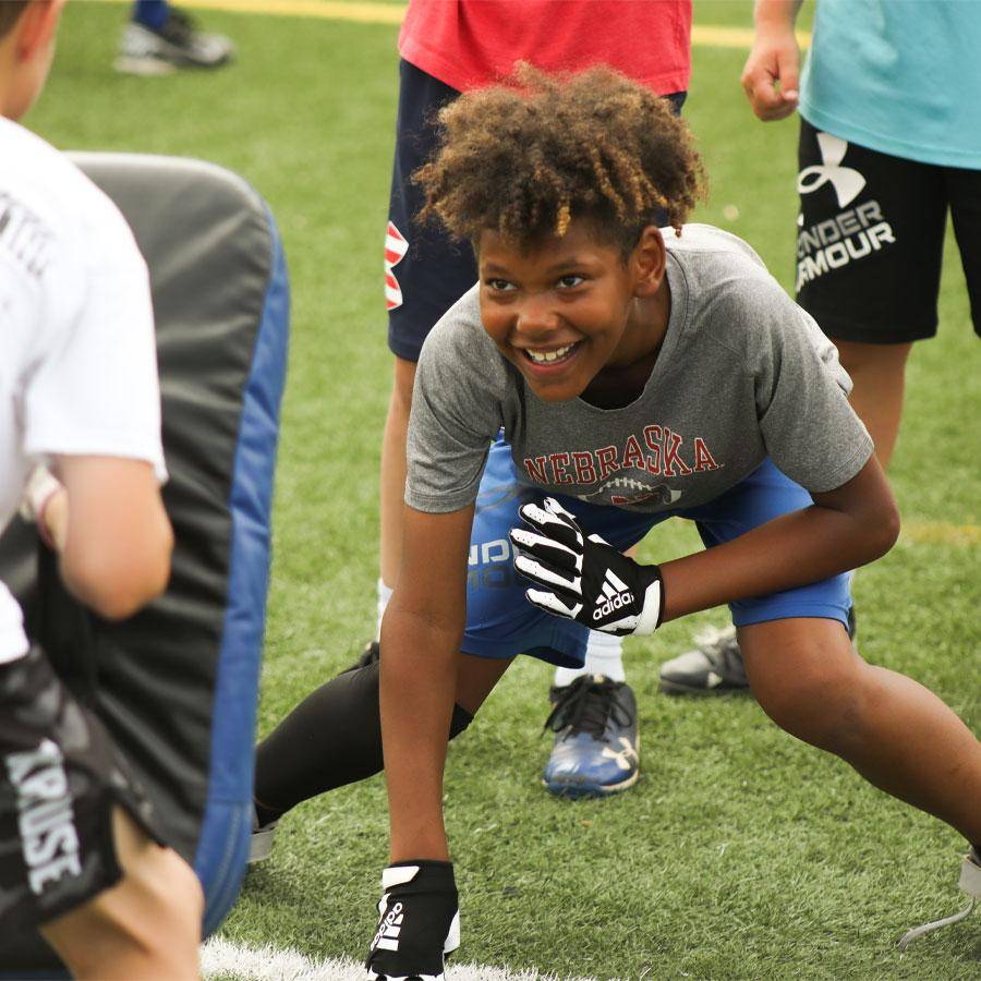 A young man practices defensive drills at a WSC football camp
