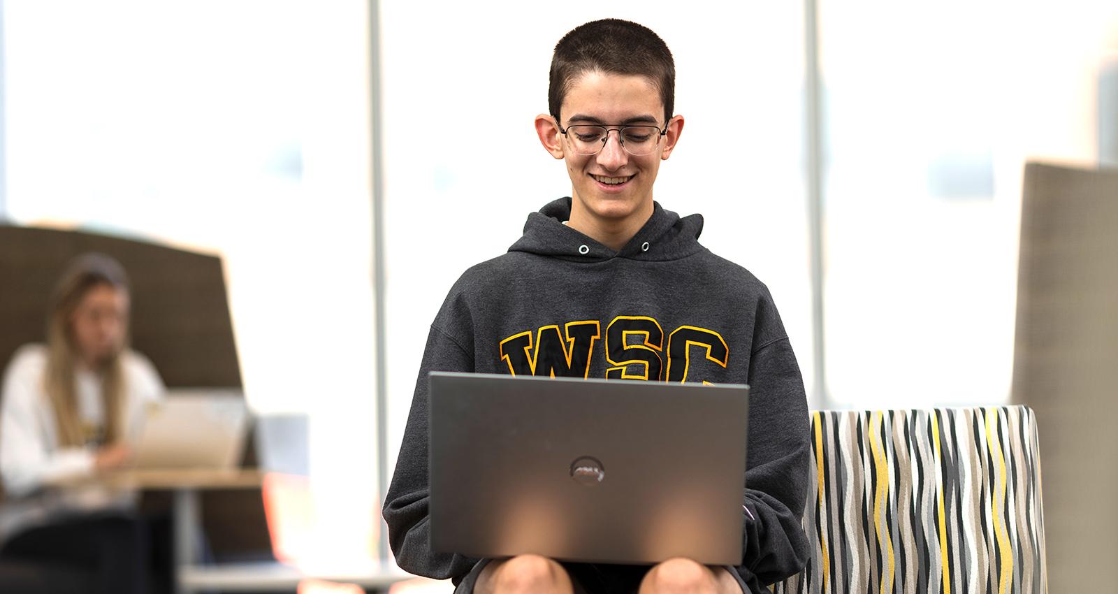 A student works on a laptop