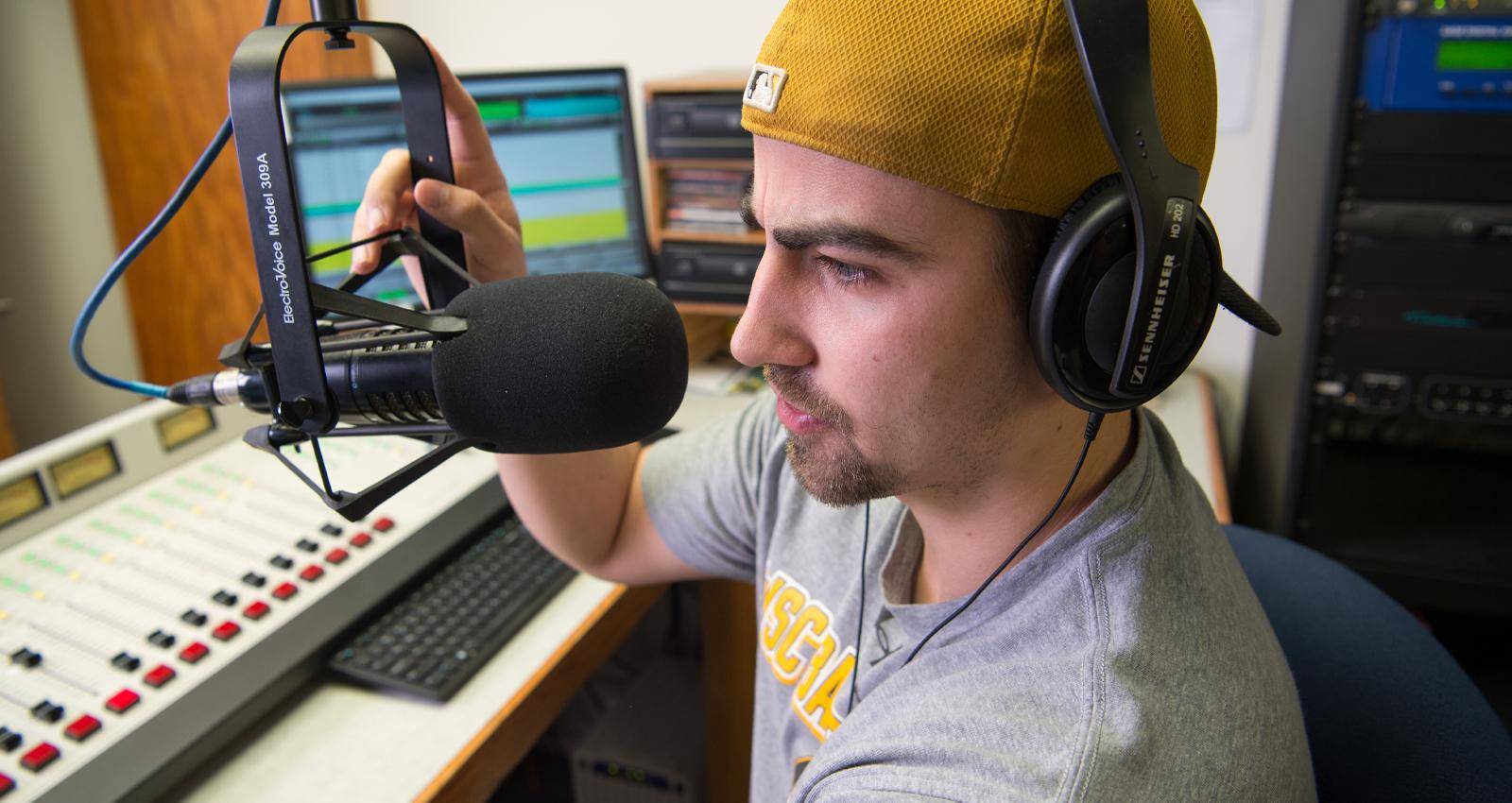A Mass Communication degree student broadcasting live during a radio show