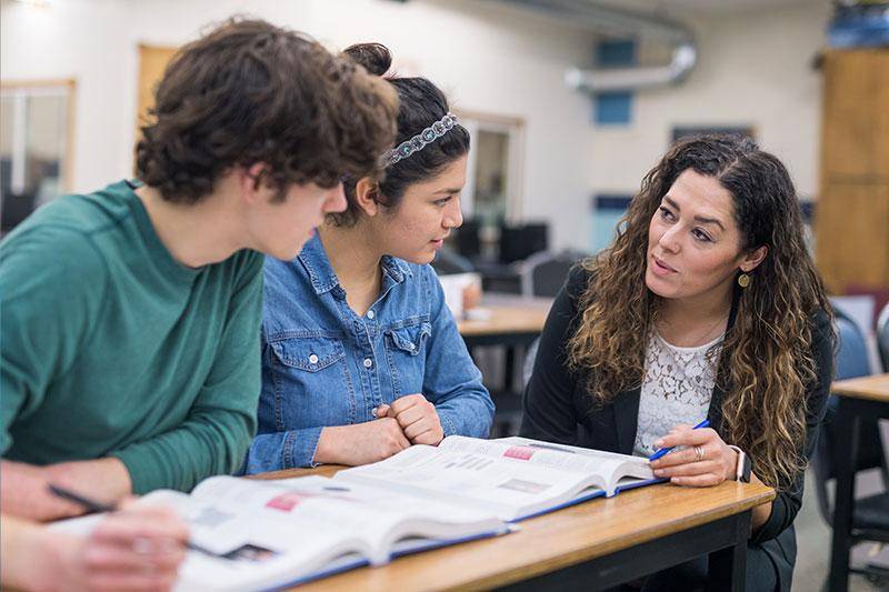 A teacher talks to students