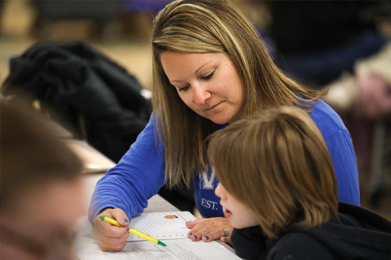 A WSC student reads with an elementary student