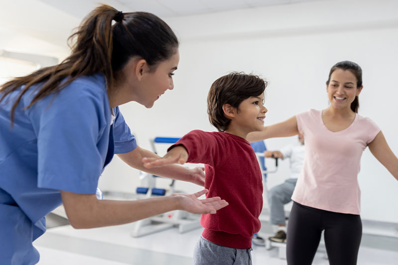 Occupational therapy degree concept featuring an OT working with a young patient