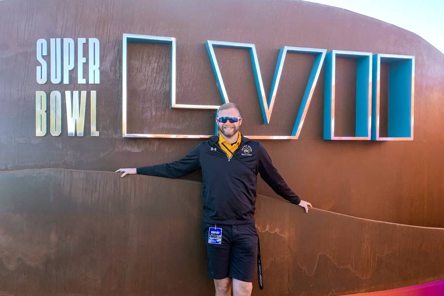 Preston Davis poses at the entrance to Super Bowl LVII