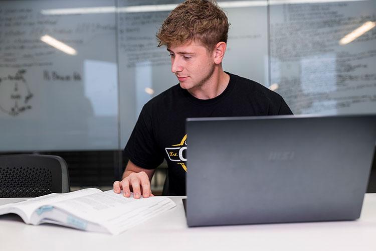 A students works on a laptop computer